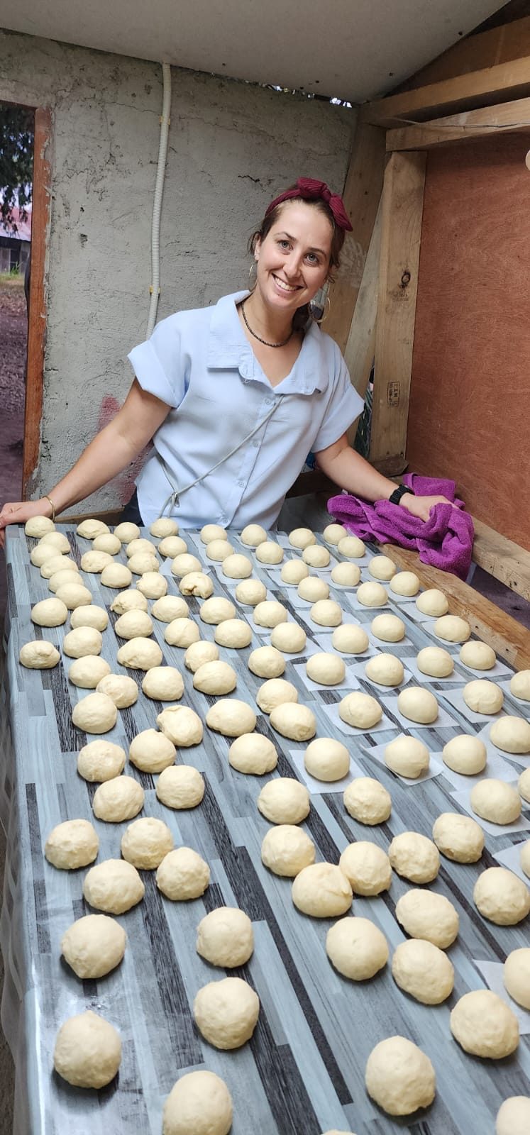 Tally behind a table of donut dough in Thailand